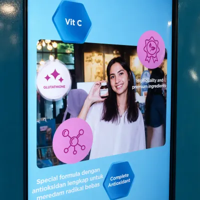 Blackmores beauty photobooth interface showing product benefits and QR download experience for event guests