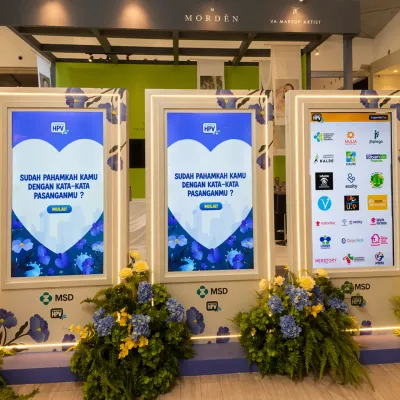 MSD HPV educational quiz event booth with large interactive digital screens and branded experiential setup for health awareness activation