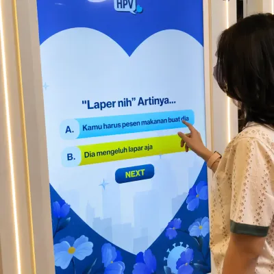 Close-up of a participant answering questions on the MSD HPV educational quiz screen as part of an interactive event gamification experience