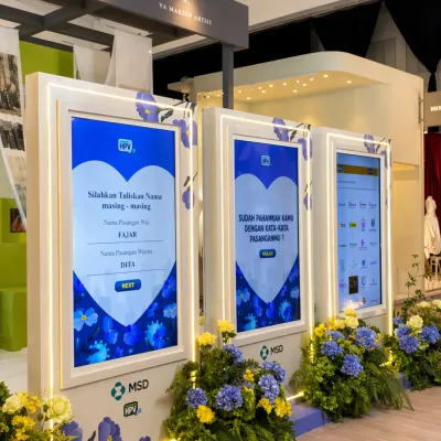 MSD HPV educational quiz installation with interactive screens, floral booth styling, and branded event technology setup for visitor engagement