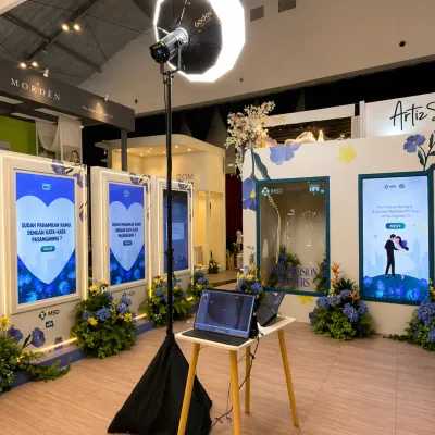 MSD HPV interactive event setup with ring light, laptop control station, digital screens, and immersive booth design for educational brand activation