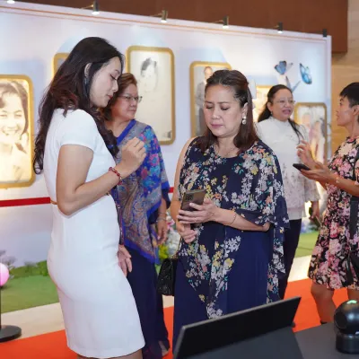 Guests completing the registration and validation process at the check-in desk for Poppy Gunadi 80th birthday event