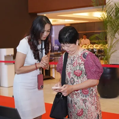Guest receiving help from the reception crew during the invitation validation and event check-in process