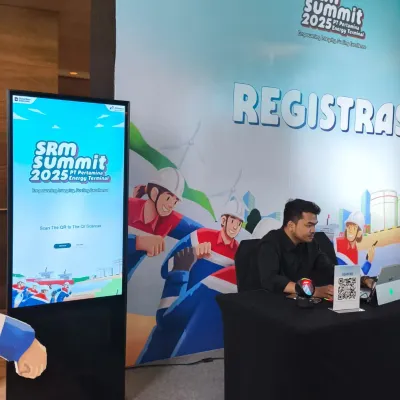 SRM Summit Pertamina 2025 registration booth with digital signage, QR scanner, and on-site check-in desk for internal Pertamina event guests