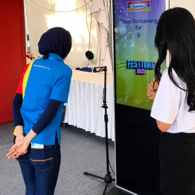 Participant playing the Scream Game interactive voice activation booth at Festival Indomaret 2025 in Jogjakarta